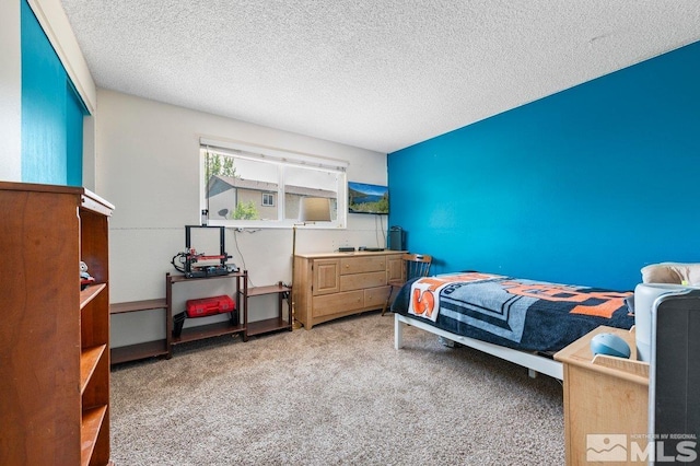 carpeted bedroom featuring a textured ceiling