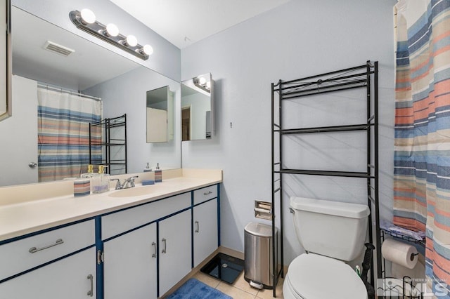 bathroom with toilet, tile patterned flooring, and vanity