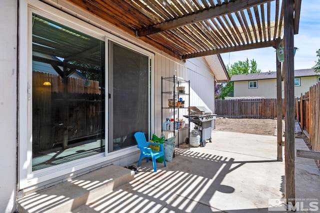 view of patio featuring grilling area and a pergola