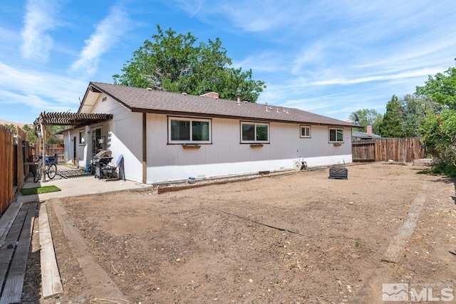 back of house with a pergola and a patio