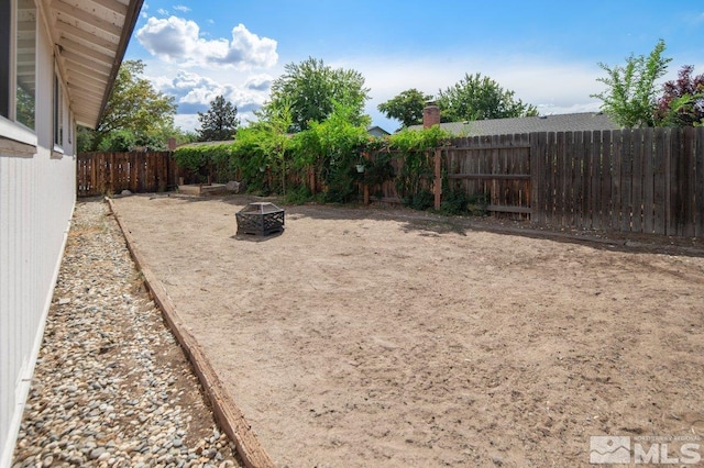 view of yard with an outdoor fire pit