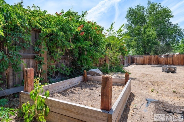 view of yard with a fire pit