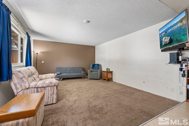 sitting room featuring a textured ceiling and light colored carpet