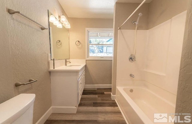 full bathroom with toilet, vanity, hardwood / wood-style floors, and bathing tub / shower combination