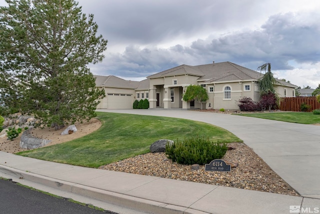 view of front of home featuring a front lawn and a garage