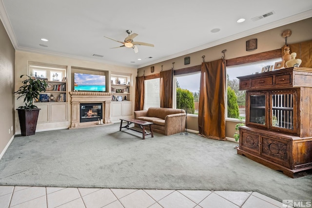 living room with a wealth of natural light, light carpet, crown molding, and built in features