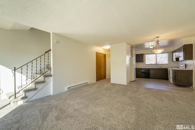 unfurnished living room featuring baseboard heating, a textured ceiling, and light carpet