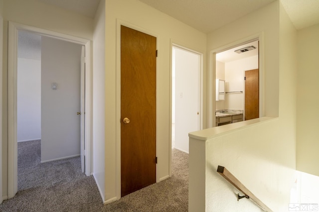 hallway with carpet floors