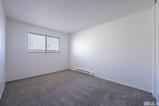 spare room featuring a textured ceiling, a baseboard radiator, and carpet flooring