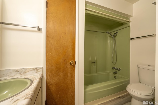 full bathroom featuring toilet, vanity, hardwood / wood-style flooring, and washtub / shower combination