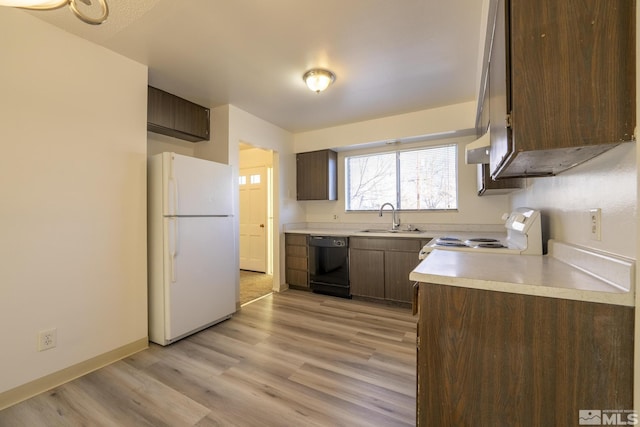 kitchen with white appliances, dark brown cabinets, light wood-type flooring, and sink