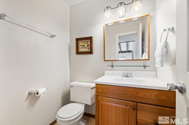 bathroom with toilet and vanity