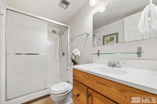 bathroom featuring toilet, walk in shower, and vanity