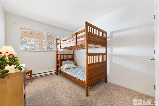 bedroom with light colored carpet and a baseboard heating unit