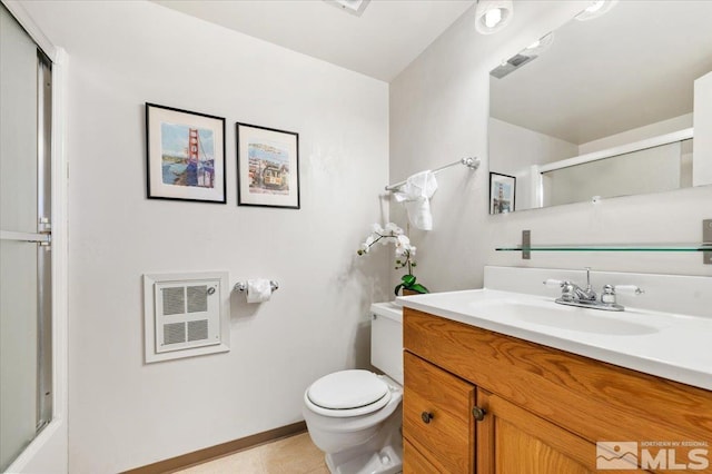 bathroom featuring toilet, an enclosed shower, vanity, and heating unit