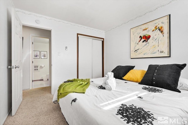 bedroom featuring a closet and light carpet