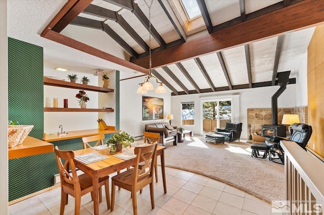 carpeted dining area featuring a chandelier, lofted ceiling with beams, and a wood stove