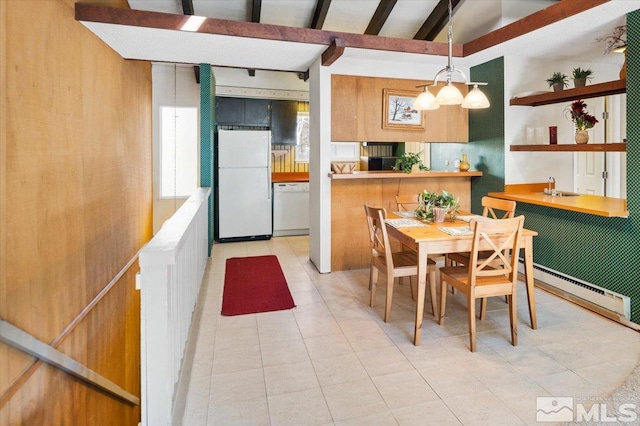 dining area with vaulted ceiling with beams, wooden walls, sink, an inviting chandelier, and a baseboard radiator