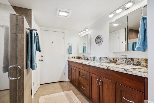 bathroom featuring an enclosed shower and vanity