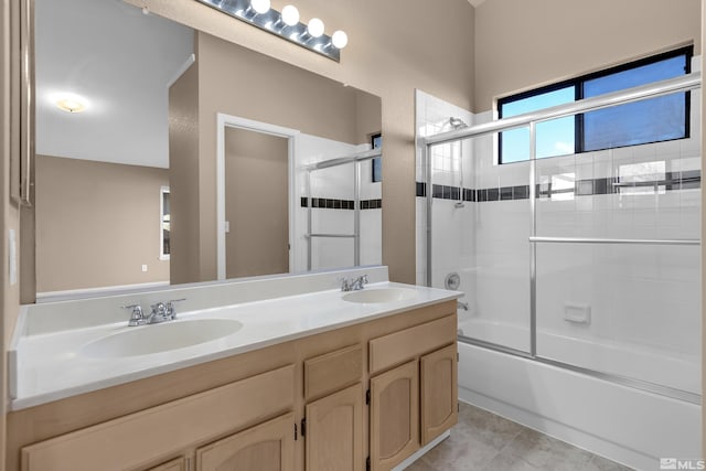 bathroom featuring shower / bath combination with glass door, tile patterned flooring, and vanity