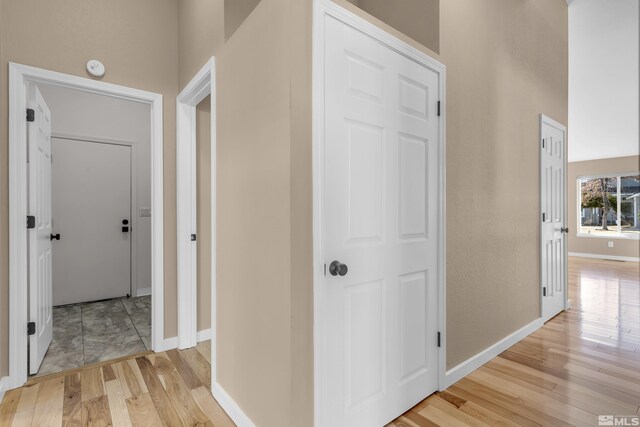 hallway with light hardwood / wood-style flooring