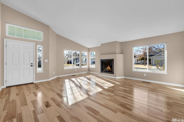 interior space featuring lofted ceiling and light hardwood / wood-style floors