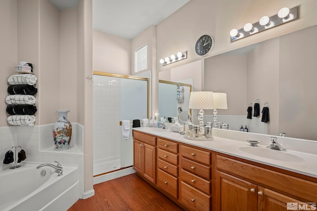 bathroom with plus walk in shower, vanity, and hardwood / wood-style flooring