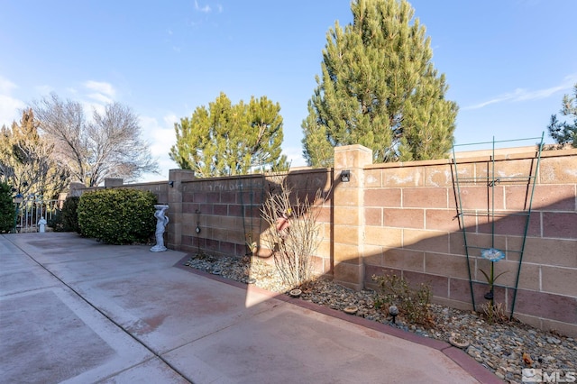 view of gate with a patio area