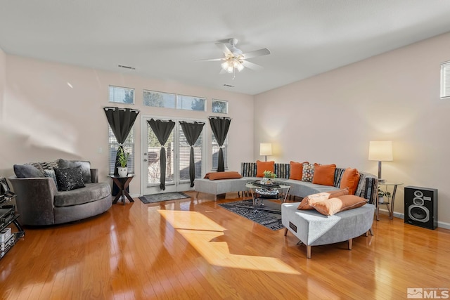 living room featuring hardwood / wood-style floors and ceiling fan