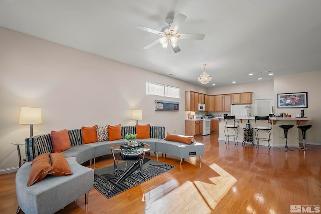 living room with light wood-type flooring and ceiling fan