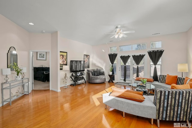 living room featuring ceiling fan and hardwood / wood-style floors