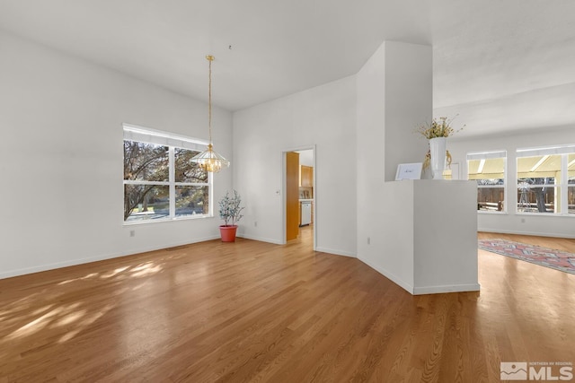 interior space featuring hardwood / wood-style flooring, a chandelier, and plenty of natural light