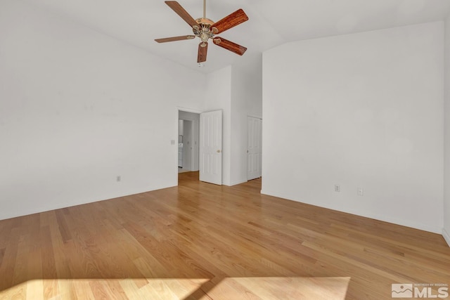 unfurnished room with light hardwood / wood-style floors, ceiling fan, and vaulted ceiling