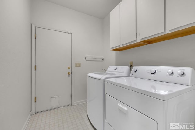 laundry room with separate washer and dryer and cabinets