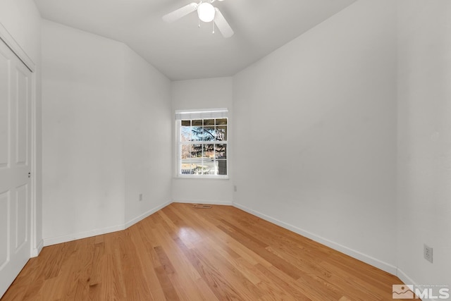 empty room with ceiling fan and light wood-type flooring