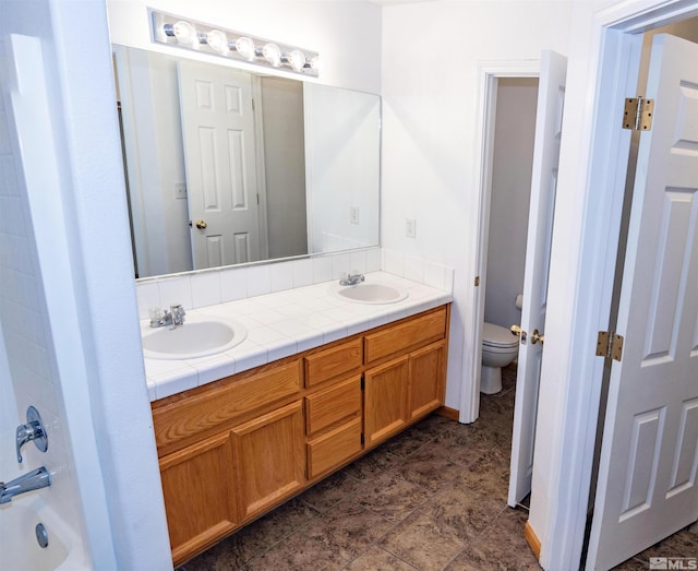 bathroom featuring toilet and vanity