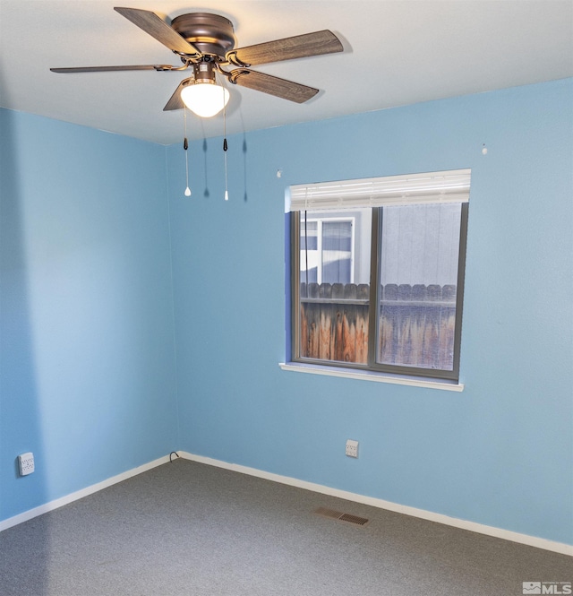 unfurnished room with ceiling fan and carpet floors