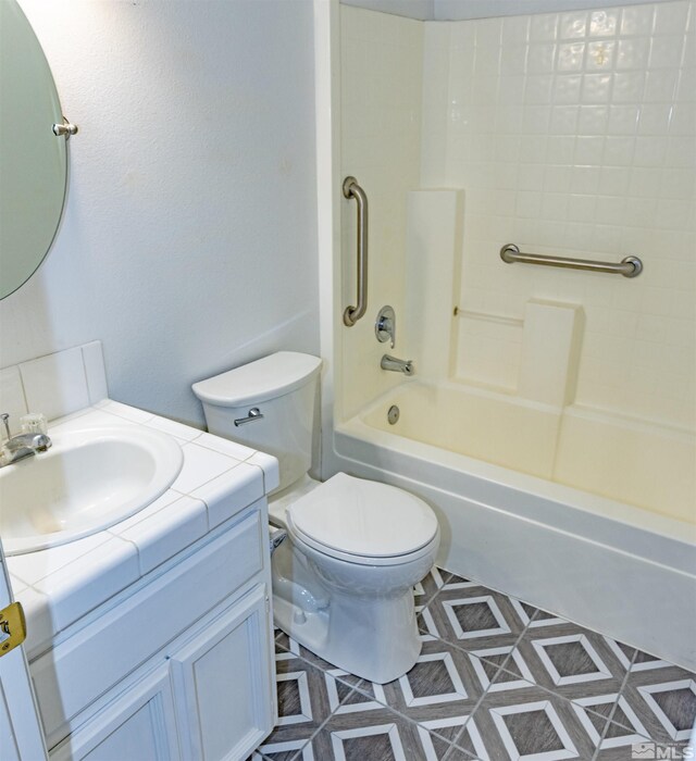 full bathroom with toilet, vanity, tile patterned flooring, and  shower combination