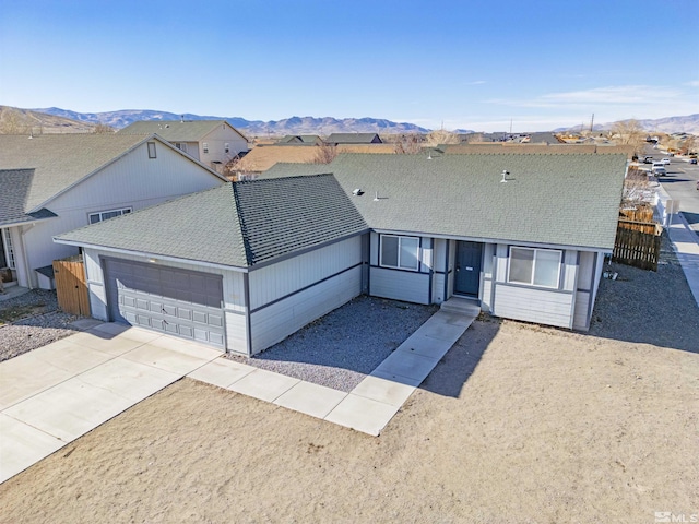 ranch-style house featuring a garage and a mountain view