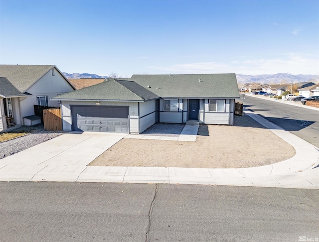 single story home featuring a garage and a mountain view