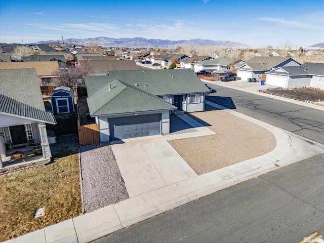 view of front of property with a garage and a mountain view