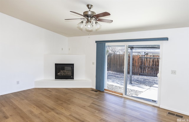 unfurnished living room with hardwood / wood-style floors and ceiling fan