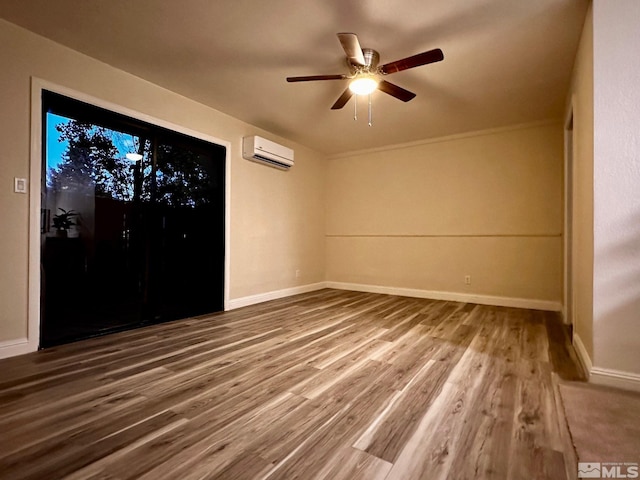 unfurnished room featuring wood-type flooring, ceiling fan, and a wall mounted air conditioner