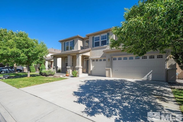 view of front of property with a garage and a front lawn