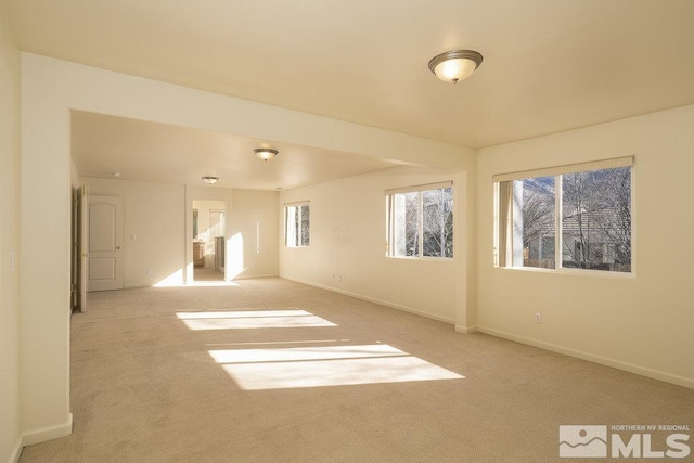 unfurnished room with light colored carpet