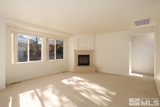 unfurnished living room featuring light colored carpet