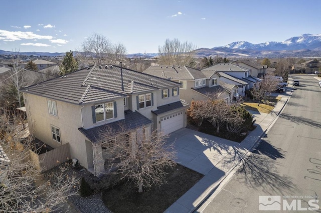 birds eye view of property with a mountain view