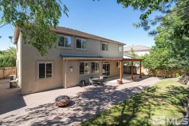 rear view of house featuring a pergola, a fire pit, and cooling unit