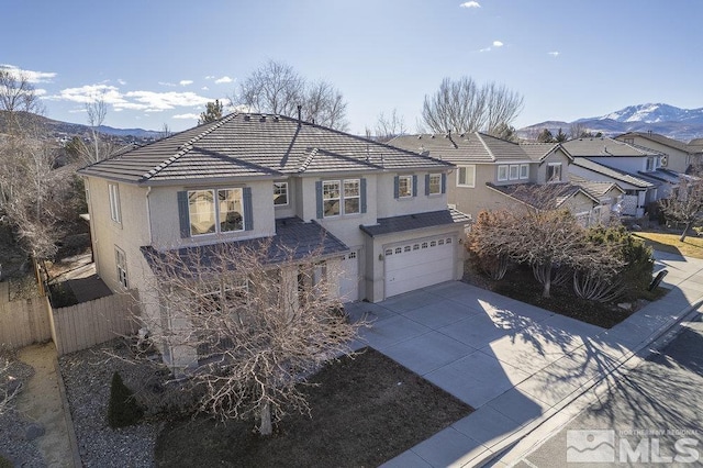 view of front of property featuring a garage and a mountain view