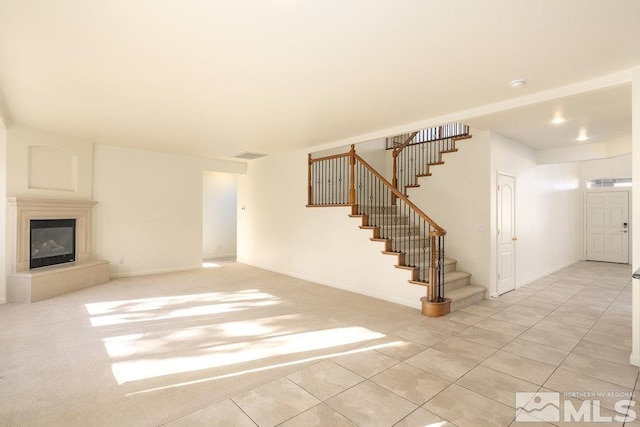 unfurnished living room featuring light tile patterned flooring